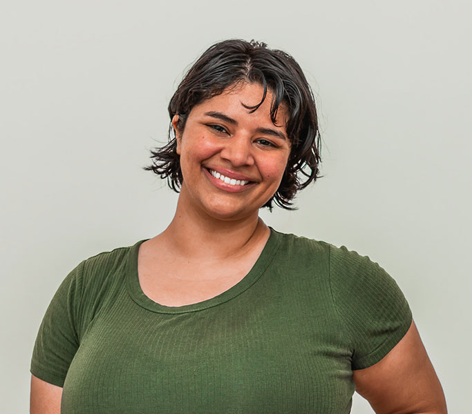 A smiling woman in a green t - shirt.
