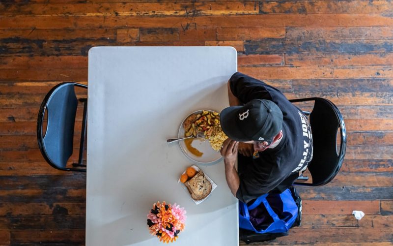 A man sitting at a table eating food.